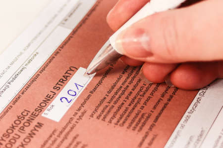 Hand Filling out Tax Form