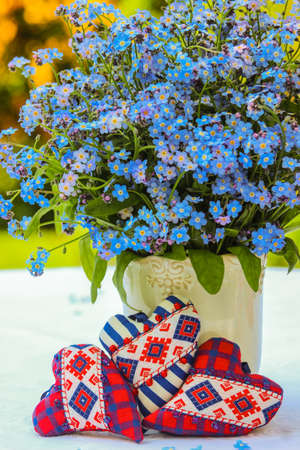 Three hearts and a bouquet of forget-me-notsの写真素材