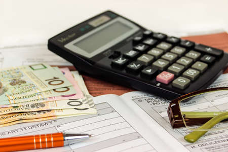 US tax forms with calculator, glasses and pen.の写真素材