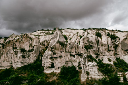 Landscape of white rock formations and cliffs under dramatic cloudy sky