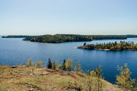 Landscape of blue lake deep in the light of the sun in the daytime, clouds in the sky
