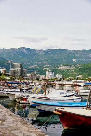 Yacht parking in the seaport, boats in the water of the lake, landscape of the marina on a cloudy dayの写真素材