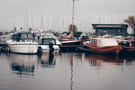 Yacht parking in the seaport, boats in the water of the lake, landscape of the marina on a cloudy...