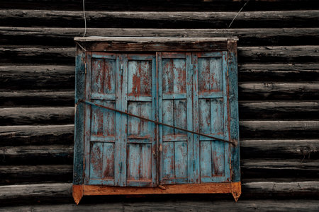 Wooden shutters on rustic cottage wallの写真素材
