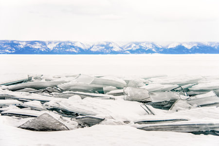 Icy hummocks on the surface of a frozen lake in winter, ice and snow texture