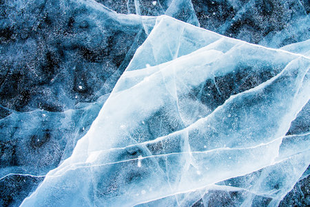 Deep blue ice texture, lake water frozen in winterの写真素材