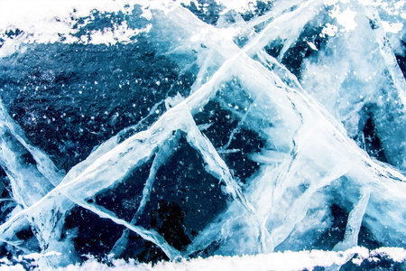 Deep blue ice texture, lake water frozen in winter, icy wallpaper