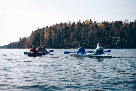 Active holidays on the lake, kayaking on the water, tourism on a cloudy dayの写真素材