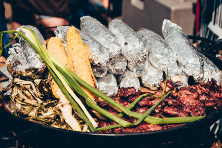 Grilled corn and meat, barbecue outdoor food picnic outsideの写真素材