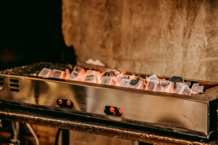 Small barbecue for grilling meat and vegetables with glowing coalsの写真素材
