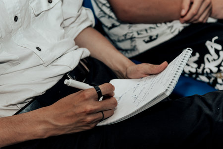 Writing notes in notebook with pen close up
