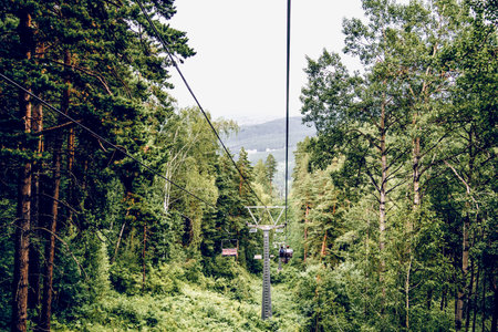 Landscape of snowy Siberia mountains, mountain range in haze in summerの写真素材