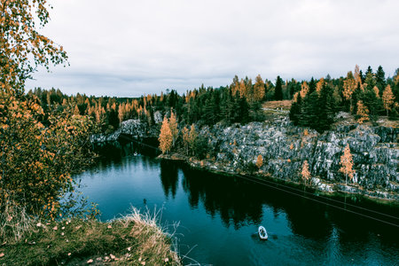 Landscape of blue lake deep in the light of the sun in the daytime, clouds in the sky Ruskeala Karelia Russiaの写真素材