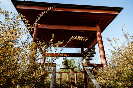 Many small bells hang on the belfry of the bell tower of the Christian temple of the churchの写真素材