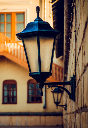 Metal Glass Pendant Lantern Hanging On Brick Wall Of Old Historic Buildingの写真素材