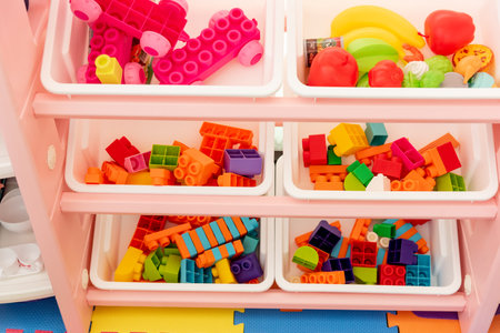 Playroom for preschool children, colored toys scattered around the room Montessoriの写真素材