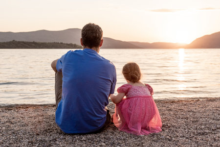 Family father and daughter on the beach, man and girl child on summer vacationの写真素材