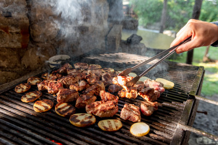 Chicken and pork meat and vegetables is cooked on the rostil brazier grill, traditional oriental...