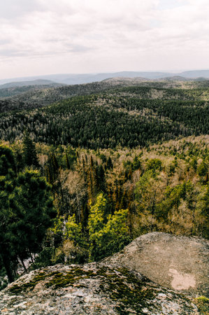 Landscape of snowy Siberia Krasnoyarsk mountains, mountain range in haze in summerの写真素材