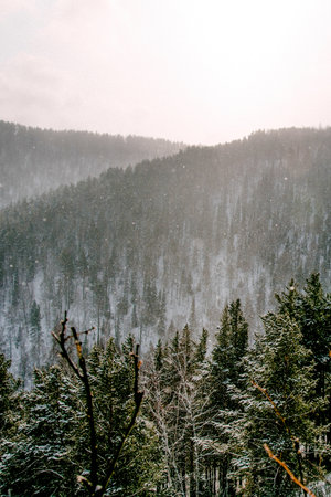 Landscape of snowy Siberia Krasnoyarsk mountains, peak range in haze winterの写真素材