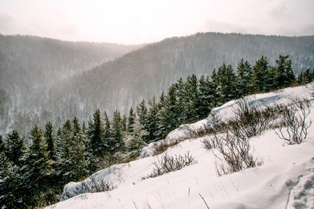 Landscape of snowy Siberia Krasnoyarsk mountains, peak range in haze winterの写真素材