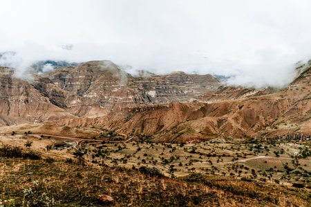 Landscape of Dagestan mountains, mountain range in haze in summer Russiaの写真素材
