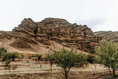 Landscape of Dagestan mountains, mountain range in haze in summer Russia