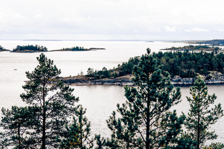 Landscape of blue lake deep in the light of the sun in the daytime, clouds in the sky Ladoga skerries Kareliaの写真素材