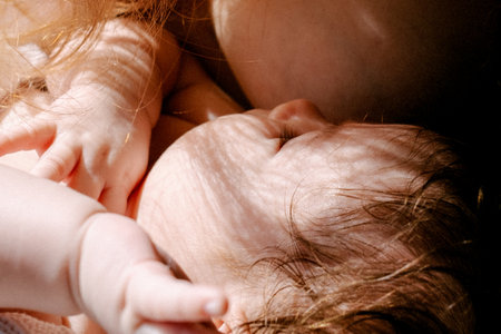 Woman breastfeeding newborn baby, healthy eating of small babies, mom and baby close-upの写真素材