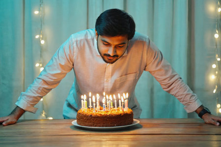 AI Generative Young man blowing out candles on cake, happy birthday celebrationの素材