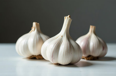 AI Generative Garlic on the table, close-up of fresh vegetable, bright kitchenの素材