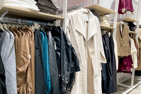 Clothes dresses, shirts, trousers hanging on hanger closets in store shopping center mallの写真素材
