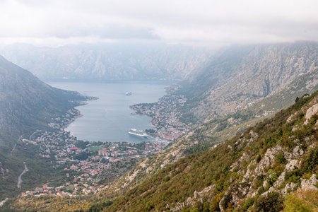 View from the Lovcen cable car to the Boka Kotor Bay, large tourist liner parked among the mountainsの写真素材