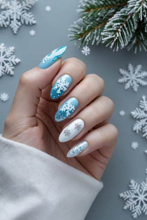 AI Generative Themed winter manicure in bright blue and white colors with holiday snow patternsの素材