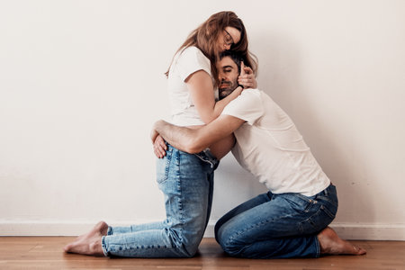 Married couple man and pregnant woman with big belly posing at photo shoot for expectant parentsの写真素材