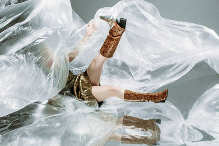 Fashion photo advertisement, woman in shoes boots with snake skin, copy space for textの写真素材