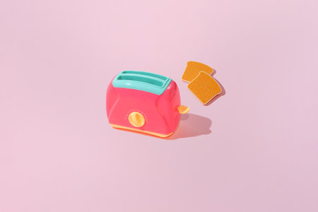 Creative pattern with slices of toast bread and toaster flat lay on pastel pink background minimalism concept with copy spaceの写真素材