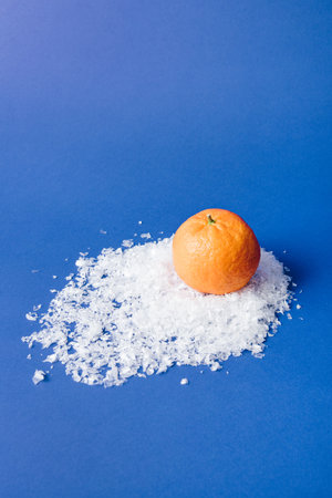Tangerines Orange Citrus Fruit on snow snowdrift blue background, Still Life Inspiration