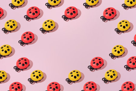 Creative abstract summer ladybug pattern flat lay on pastel pink background minimalism