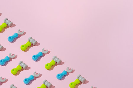 Creative abstract engineering screwdriver and hammer tool pattern flat lay on pastel pink background minimalism with copy space for textの写真素材