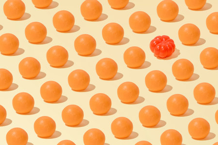 Creative abstract summer orange and tomato pattern flat lay on pastel yellow background minimalism