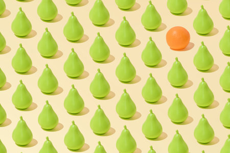 Creative abstract summer pear and orange pattern flat lay on pastel yellow background minimalismの写真素材