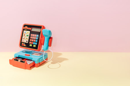 Creative abstract payment cash register composition still life on pastel yellow background minimalism with copy spaceの写真素材