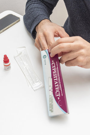 Bar, Montenegro, 8 January 2026, Man opens box with portable streptococcus bacterium testのeditorial素材