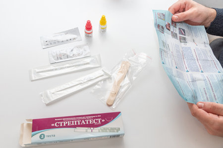 Bar, Montenegro, 8 January 2026, Man reads instructions portable streptococcus bacterium testのeditorial素材