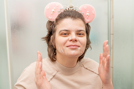 Young woman in washing face with skin cleanser, skincare and wellness daily beauty routineの写真素材