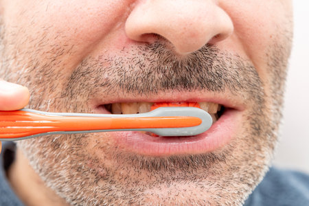 Young man brushing teeth at home in bathroom, lifestyle daily beauty routine