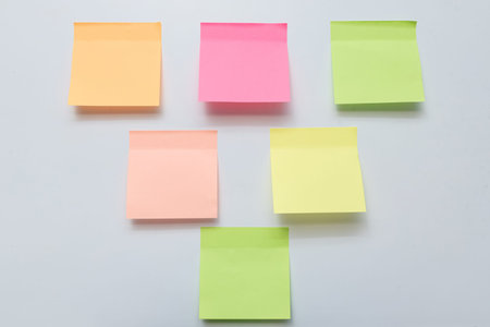 Colored Blank empty Sticky Sticker Pasted On White isolated Wall, Creative copy Space For Text