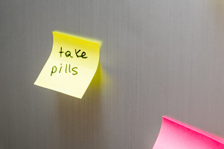 Reminder sticker glued to the refrigerator door to take pills medicine drug tablet health