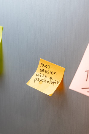 Reminder sticker pasted on refrigerator door, session with psychologist to maintain mental health